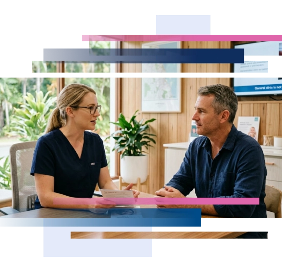 Dentist and patient engaging in a consultation at a dental clinic with plants and a wall-mounted display in the background.