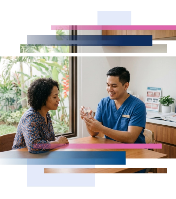 Dentist demonstrating a dental implant model to a patient in a dental office setting.