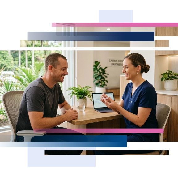 Dentist showing a mouthguard to a smiling patient in a bright dental office setting.