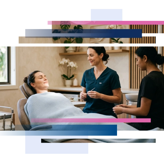 Patient relaxed in a dental chair with a dentist and assistant, in a modern clinic setting.